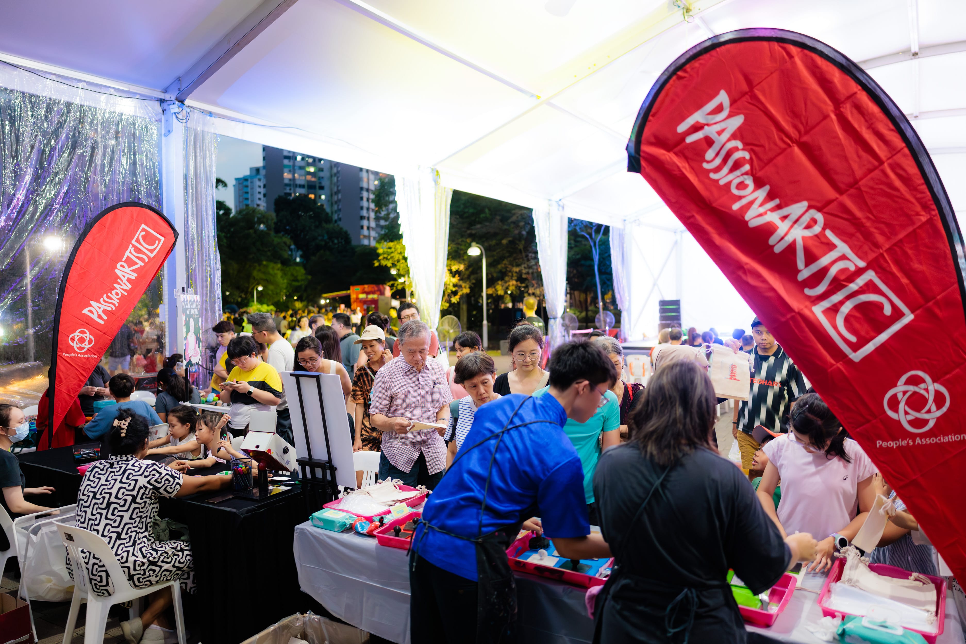 eventgoers surrounding an activity booth at the Taman Jurong CACC PAssion Arts Festival